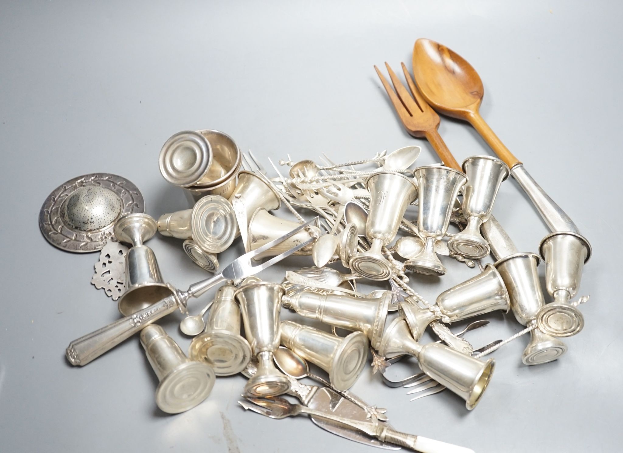 A quantity of American sterling items including four beakers, twelve assorted small goblets(weighted?), six assorted condiments(weighted?) and group of miscellaneous flatware